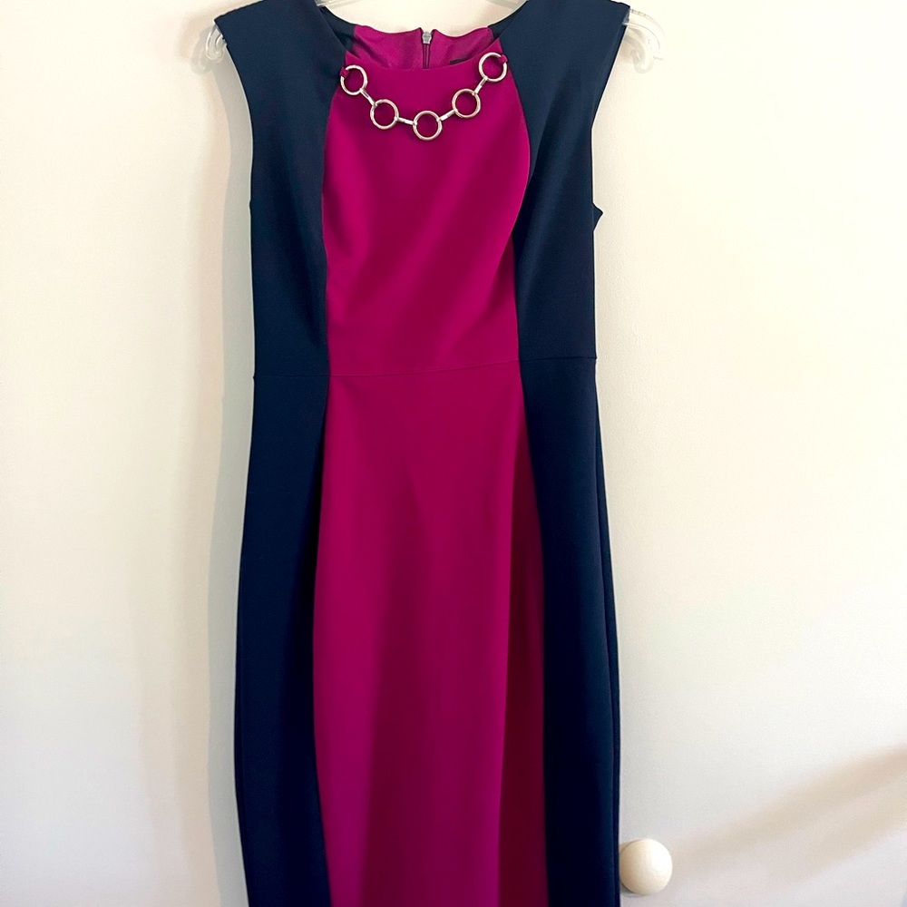 Pretty blue and pink tank dress. Features solved chain faux necklace